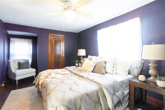 bedroom with ceiling fan and dark hardwood / wood-style flooring