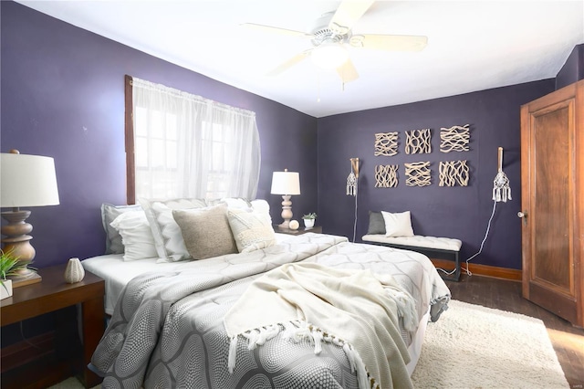 bedroom with ceiling fan and dark hardwood / wood-style floors