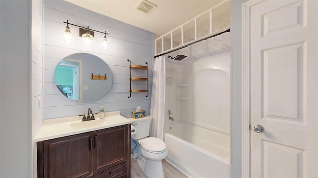 full bathroom with toilet, shower / tub combo, wood walls, and vanity