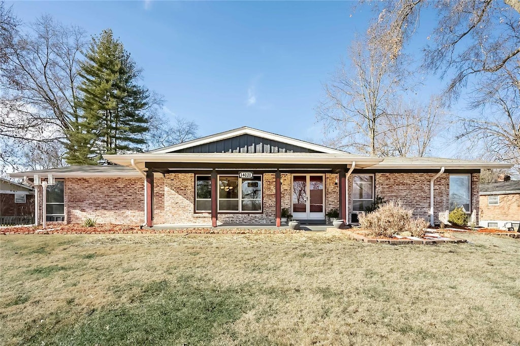 rear view of house featuring a yard