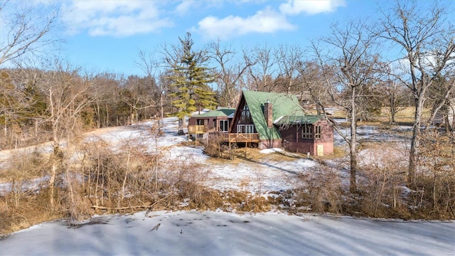 snowy yard with a wooden deck