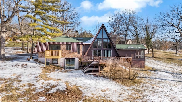 snow covered property with a deck