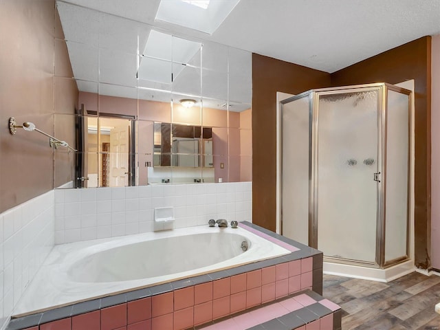 bathroom with separate shower and tub and hardwood / wood-style floors