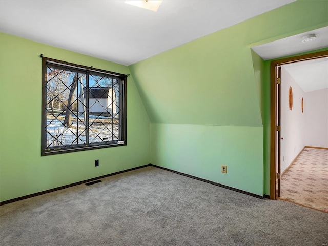 bonus room featuring lofted ceiling and carpet flooring