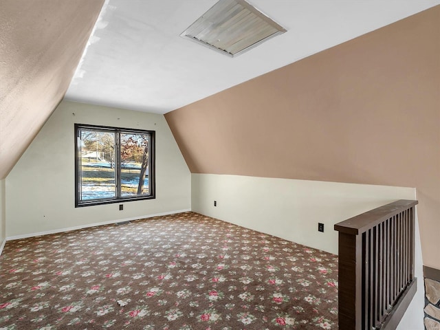 bonus room with lofted ceiling and carpet floors