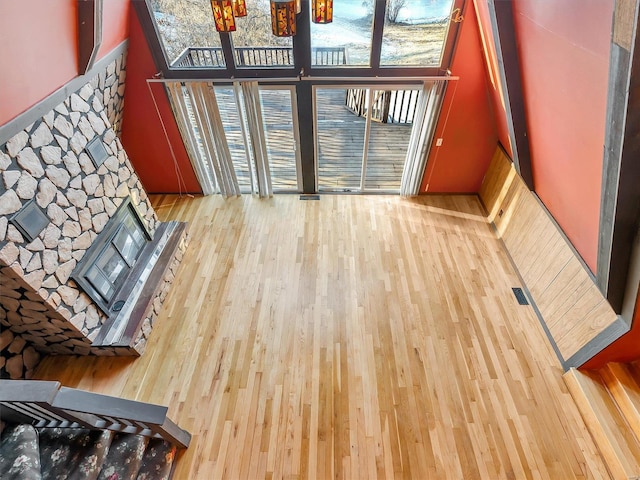 living room featuring hardwood / wood-style flooring and a towering ceiling