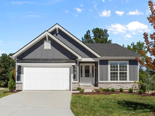 craftsman-style house featuring a front yard and a garage