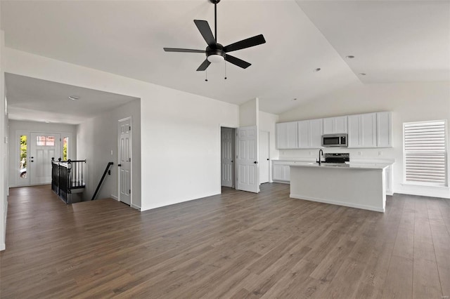 unfurnished living room with ceiling fan, dark wood-type flooring, and high vaulted ceiling