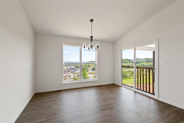 unfurnished room featuring an inviting chandelier, vaulted ceiling, and dark hardwood / wood-style floors