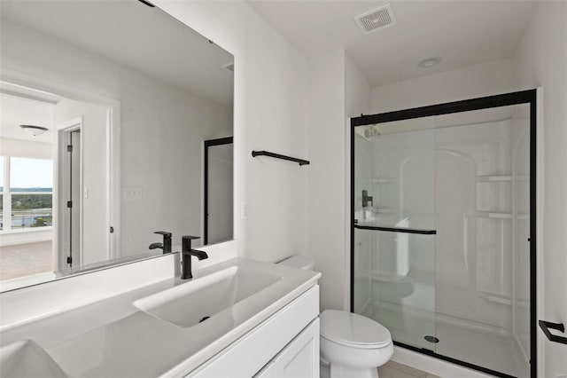 bathroom featuring an enclosed shower, vanity, and toilet