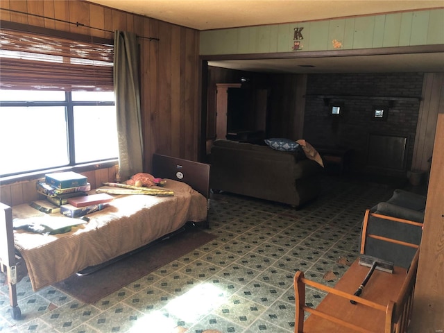 bedroom featuring wood walls