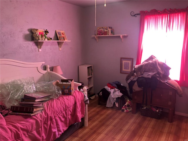 bedroom with hardwood / wood-style floors