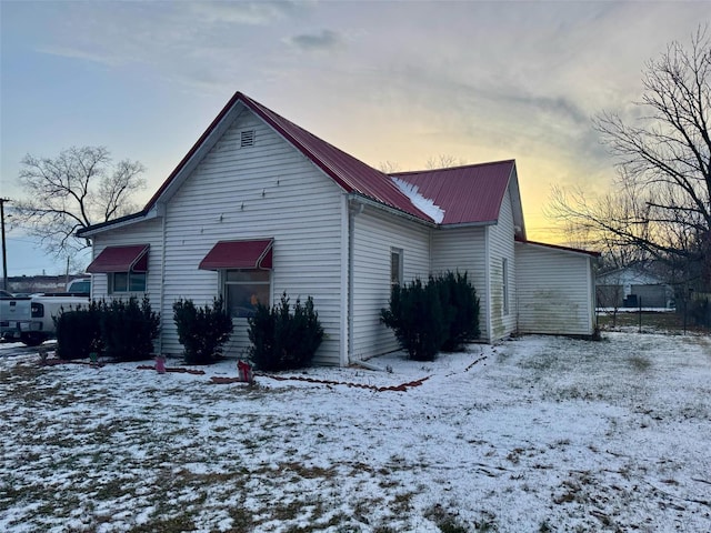 view of snow covered back of property