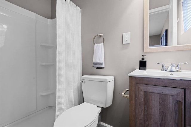 bathroom with toilet, vanity, and curtained shower