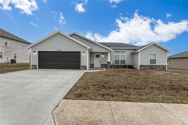 view of front of house featuring a garage, a front lawn, and central air condition unit