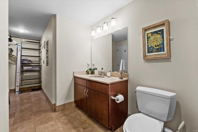 bathroom with vanity, tile patterned flooring, and toilet