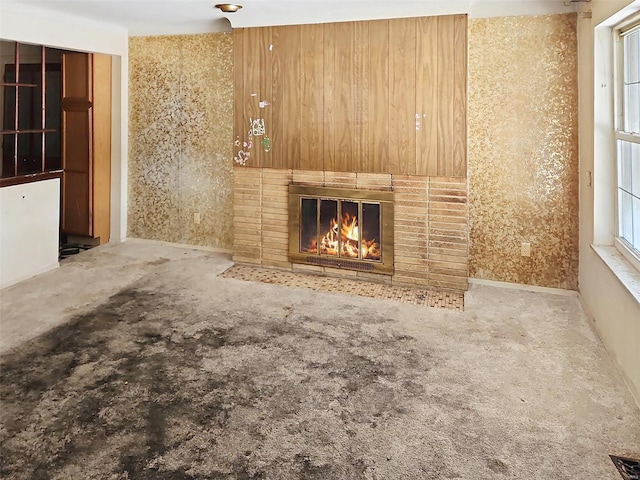 unfurnished living room featuring a brick fireplace