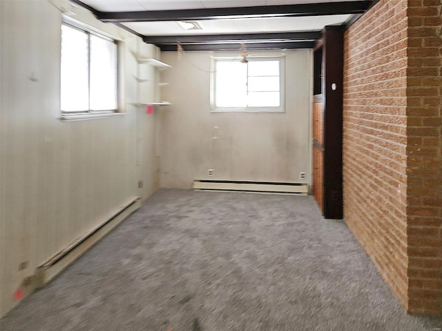 basement featuring brick wall, carpet floors, and baseboard heating