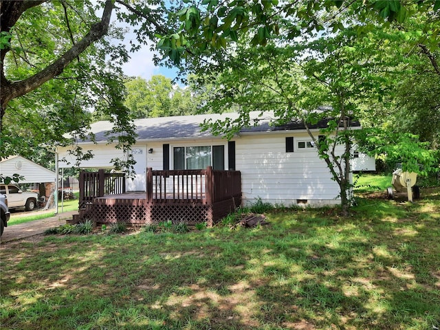 view of front of house with a deck and a front lawn