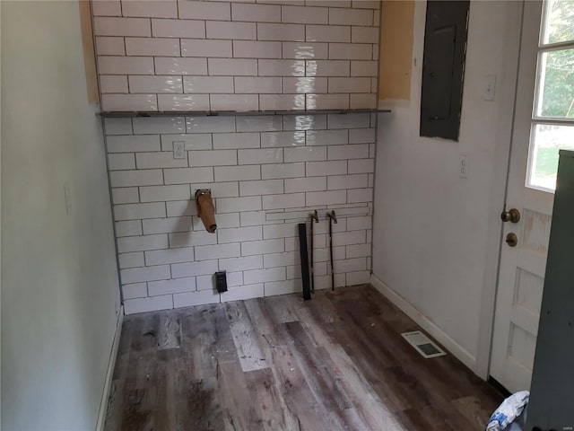 washroom with electric panel and hardwood / wood-style floors