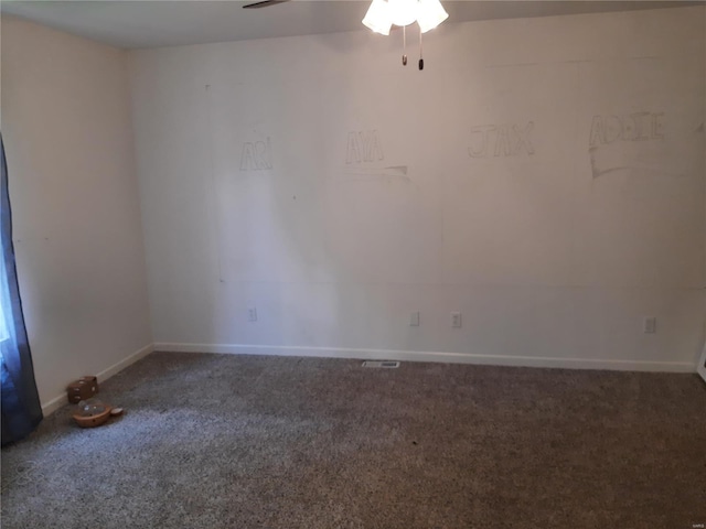 carpeted spare room featuring ceiling fan