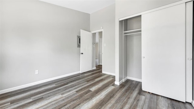 unfurnished bedroom featuring a closet and dark hardwood / wood-style floors