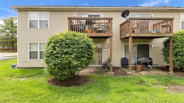 back of house with a yard and a wooden deck