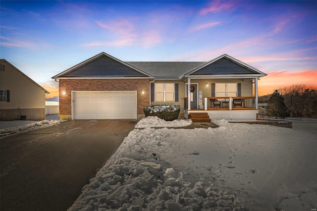 view of front of home with a porch and a garage