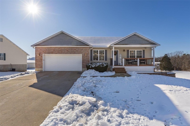 single story home with covered porch and a garage