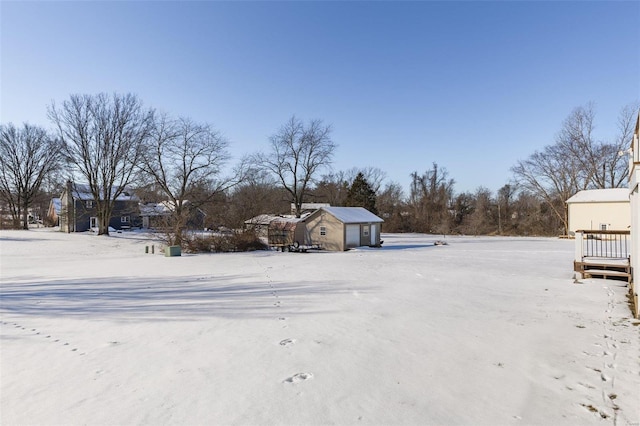 yard covered in snow with a shed