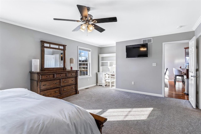 carpeted bedroom featuring ceiling fan and crown molding