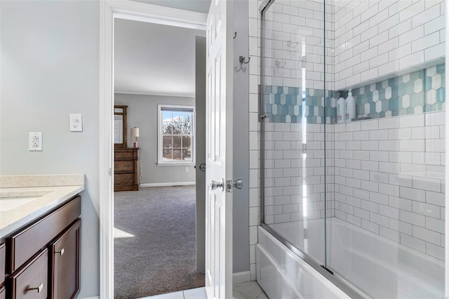 bathroom with enclosed tub / shower combo, crown molding, and vanity