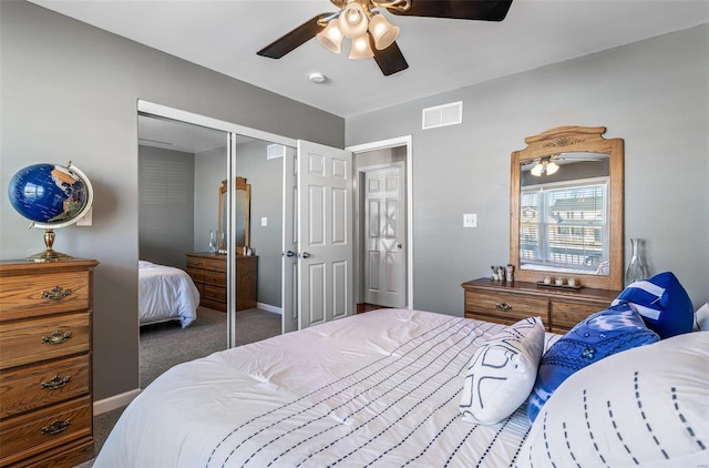 bedroom with ceiling fan, a closet, and dark colored carpet