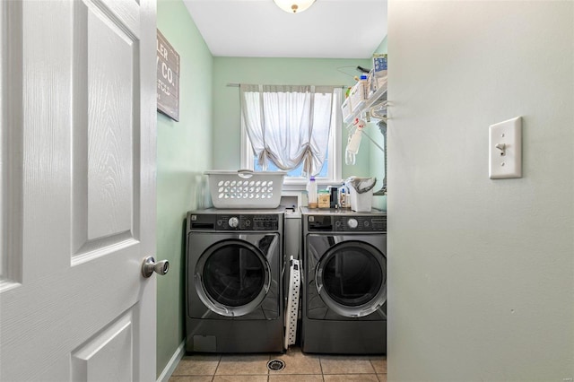 clothes washing area with light tile patterned floors and separate washer and dryer