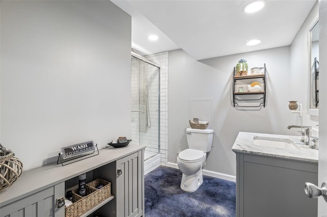 bathroom featuring toilet, vanity, and walk in shower