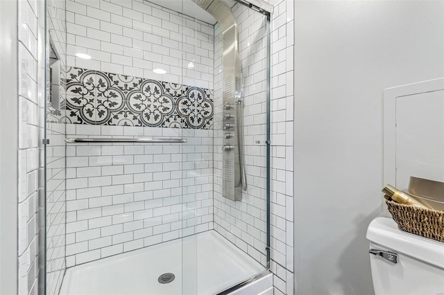 bathroom featuring an enclosed shower and toilet