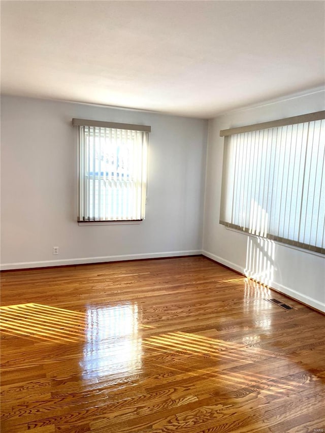 empty room with hardwood / wood-style flooring