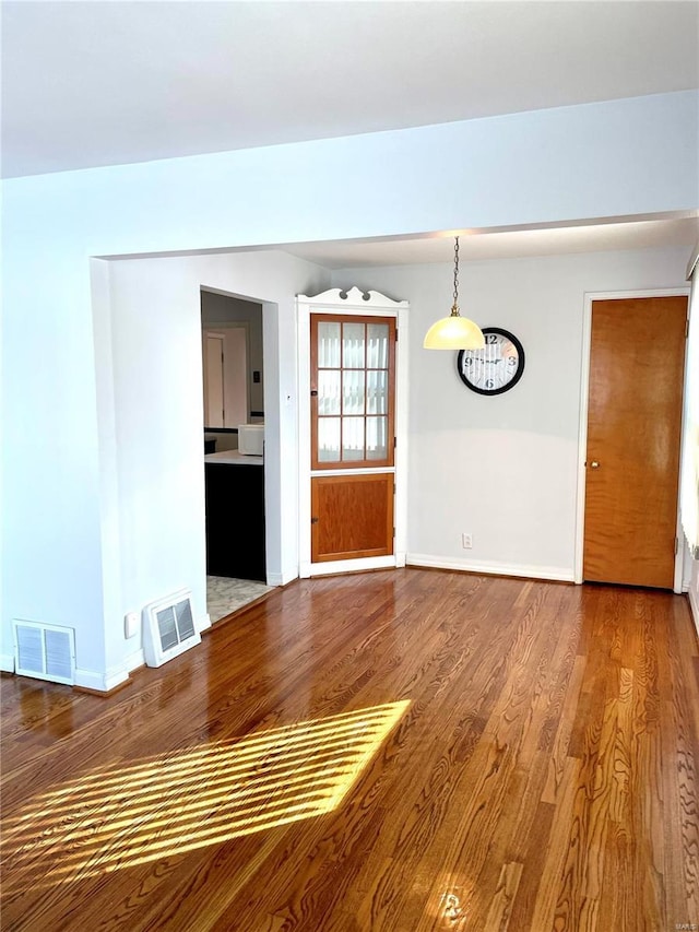 empty room with hardwood / wood-style floors