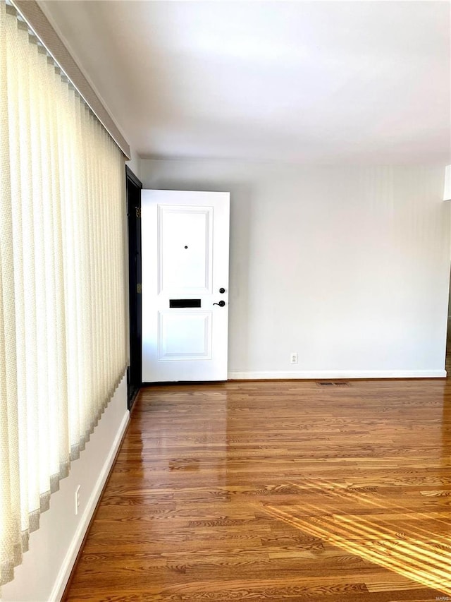 spare room with hardwood / wood-style flooring