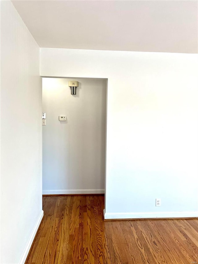 unfurnished room with wood-type flooring