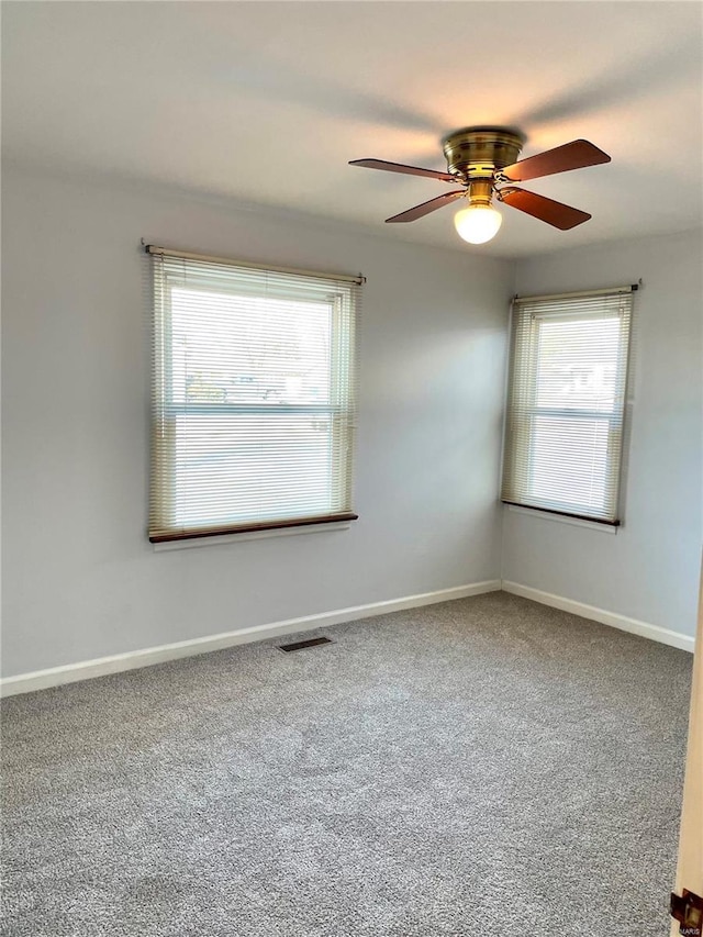 unfurnished room with ceiling fan, carpet, and a healthy amount of sunlight