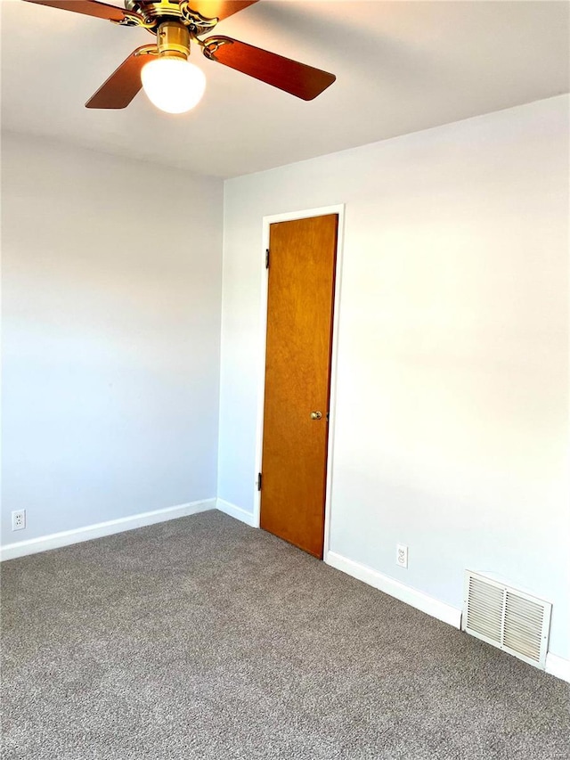 empty room featuring carpet floors and ceiling fan