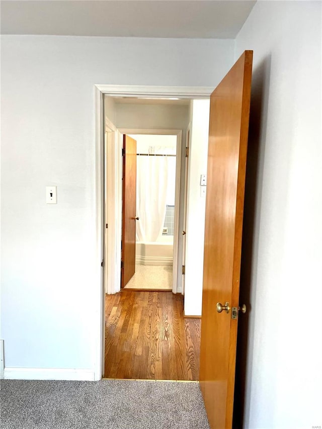 hallway with light colored carpet