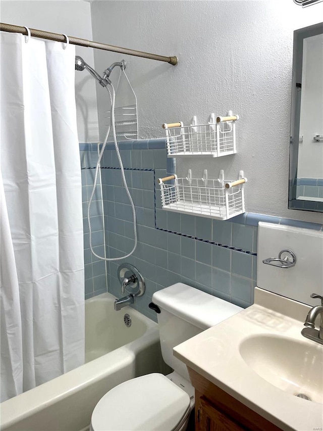 full bathroom with shower / bath combo with shower curtain, toilet, and vanity