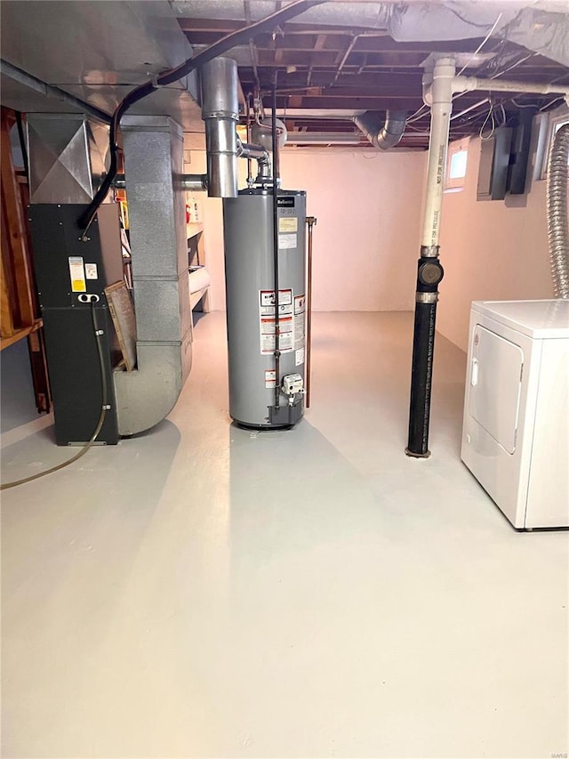 basement featuring heating unit, washer / clothes dryer, and water heater