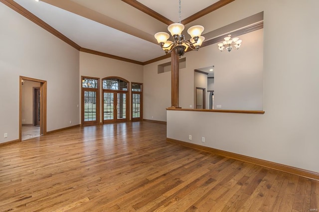 interior space featuring a notable chandelier, crown molding, a towering ceiling, and hardwood / wood-style floors