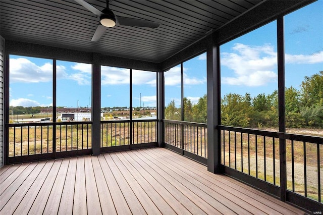 unfurnished sunroom with ceiling fan