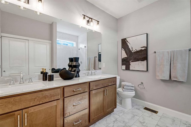 bathroom with a shower, vanity, and toilet