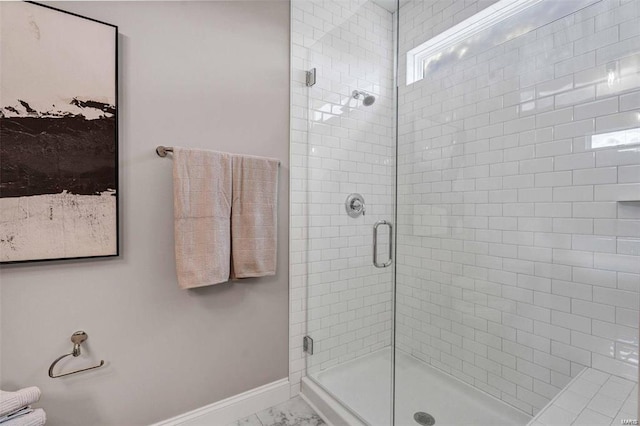 bathroom featuring a shower with door