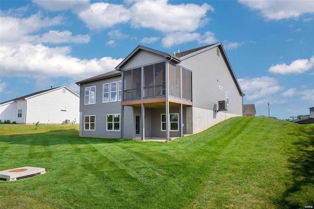 back of property with a yard and a sunroom